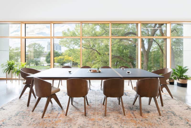 Large conference table with modern wood chairs.