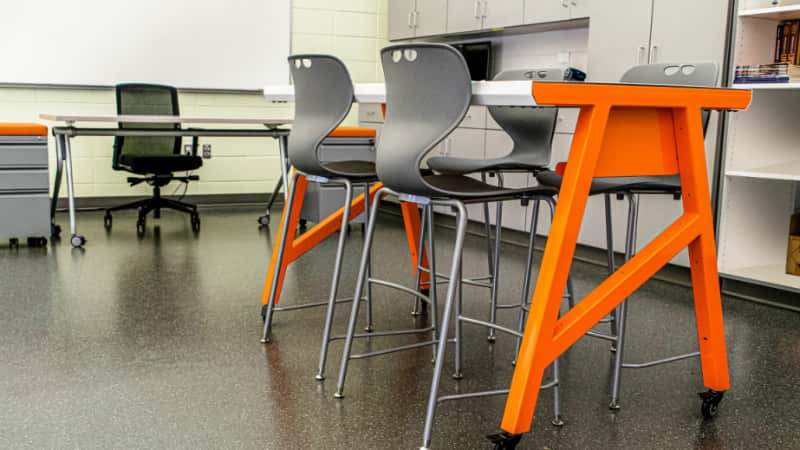 Armless chairs with tables for 4 students.